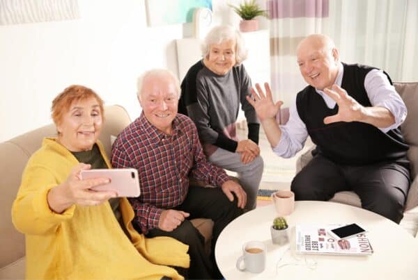 Older adults taking a selfie together, showcasing confidence and joy with gray hair.