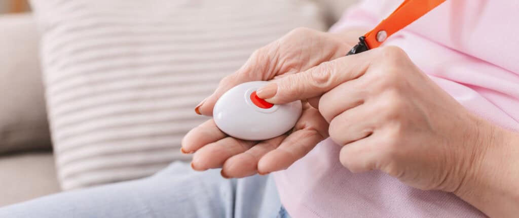 Woman with gray hair holding a remote control, showcasing confidence and style.