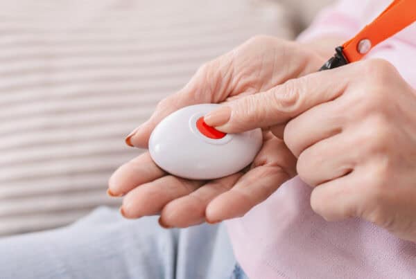 Woman with gray hair holding a remote control, showcasing confidence and style.