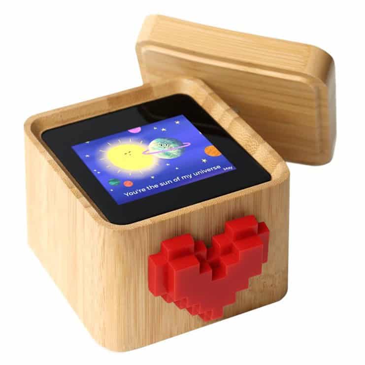 Wooden gift box with a digital screen and pixelated red heart decoration.